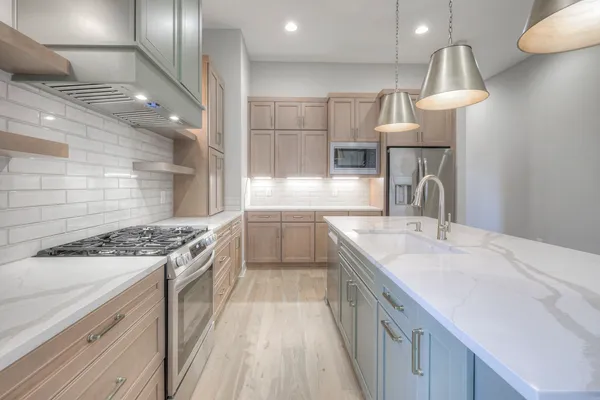 a kitchen with a sink stove and cabinets