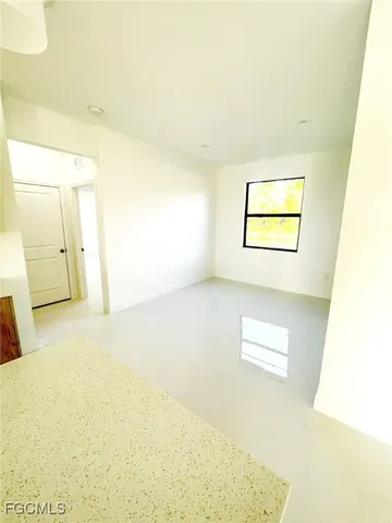 a view of a kitchen with furniture and wooden floor