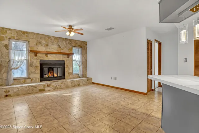 a view of an empty room with a fireplace