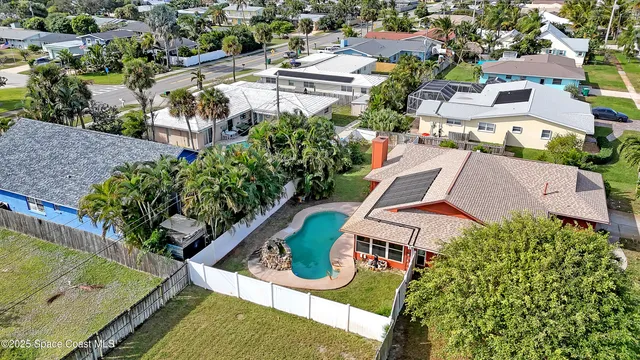 an aerial view of residential house with outdoor space and swimming pool