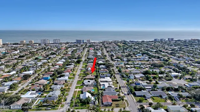 aerial view of a house with outdoor space and seating area