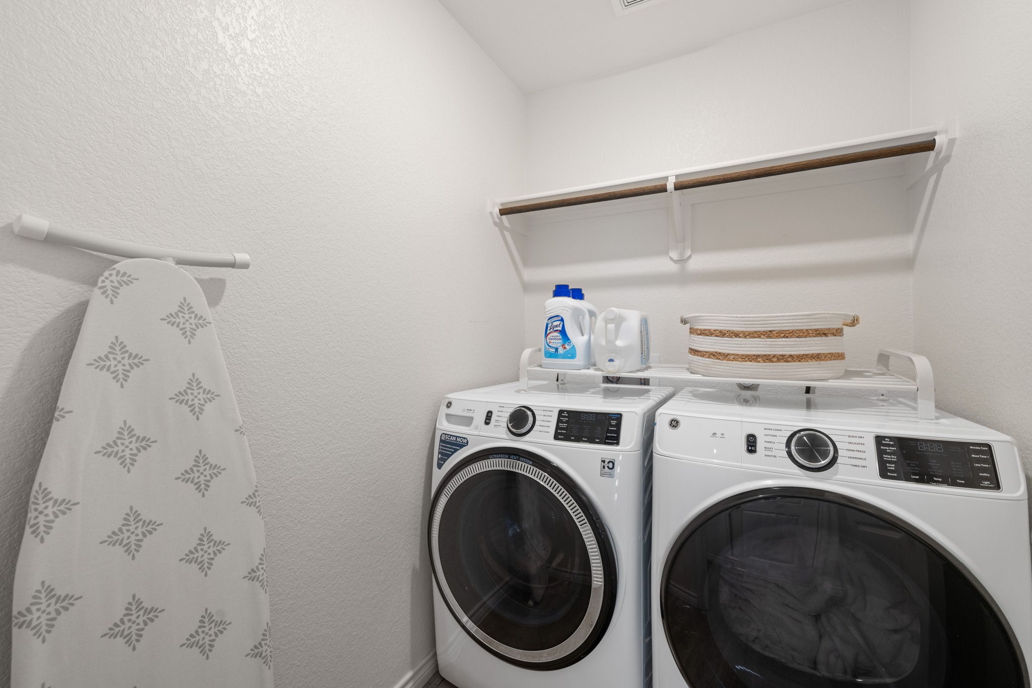 129 Maybelline Road Jarrell, TX 76537 - Photo 22 of 28 A functional laundry area includes overhead shelving and modern front-load appliances.