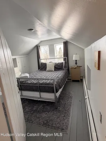 a bedroom with a bed and a large window