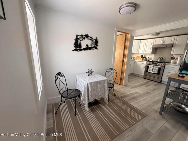 a view of a livingroom with furniture and a workspace