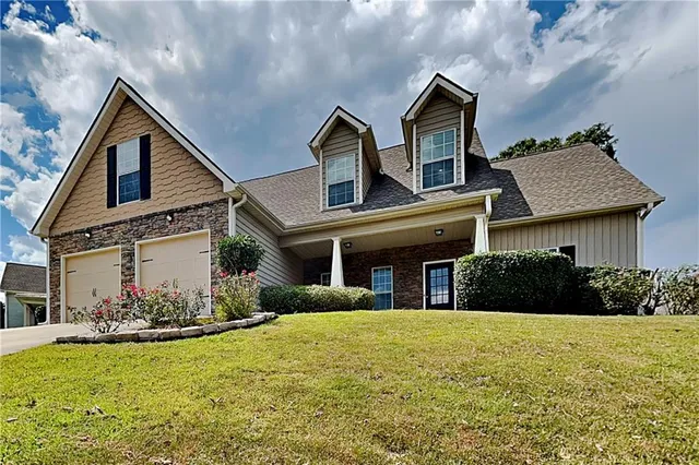 a front view of a house with a yard