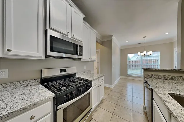 a kitchen with granite countertop a stove and a sink
