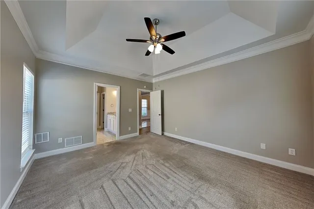a view of an empty room with a ceiling fan