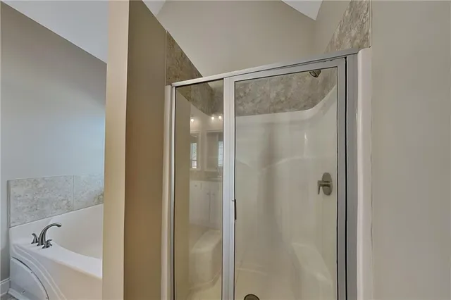 a bathroom with a bathtub and shower