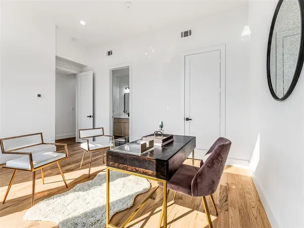 a living room with furniture and a mirror