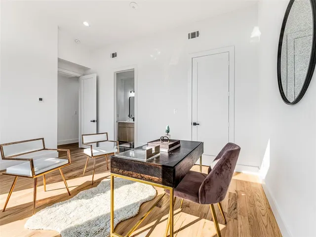 a living room with furniture and a mirror