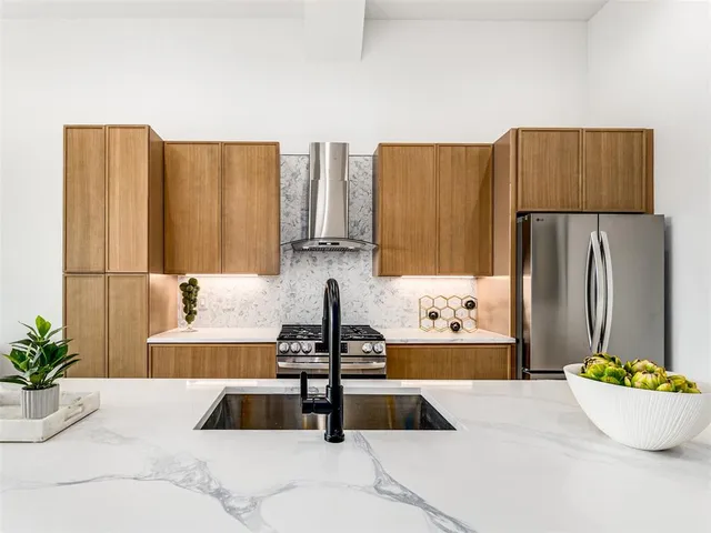 a kitchen with a sink and a refrigerator