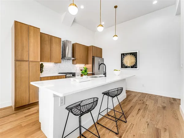 a kitchen with a table chairs refrigerator and microwave