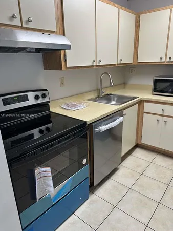 a kitchen with a stove and a sink