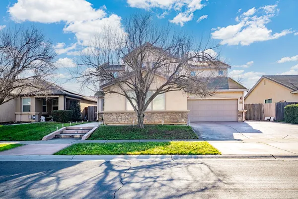 a kitchen with stainless steel appliances granite countertop wooden cabinets a stove a sink and a refrigerator