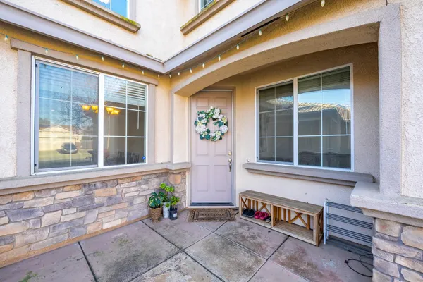 a kitchen with stainless steel appliances granite countertop a stove a refrigerator a oven a sink a stove a dining table and chairs with wooden floor