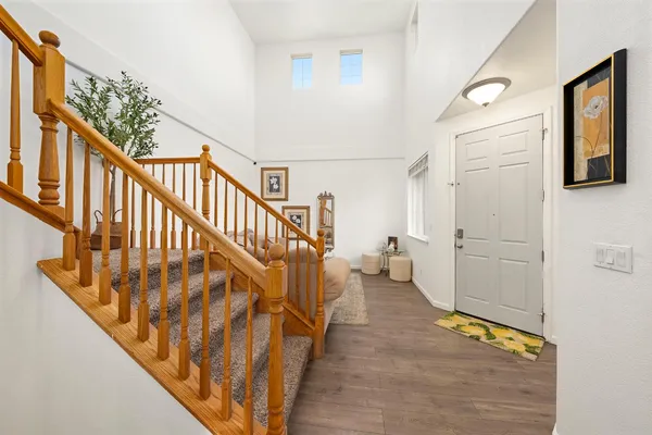 a kitchen with stainless steel appliances granite countertop wooden cabinets a sink and a large window