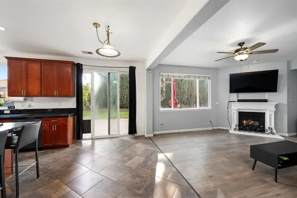 a living room with furniture fireplace and flat screen tv
