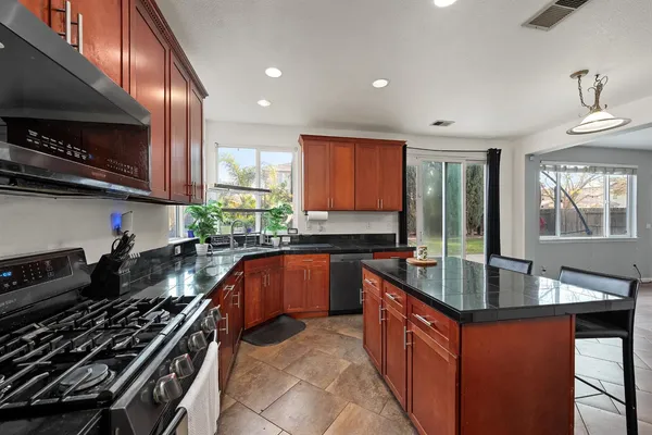 a room with gym equipment and a chandelier fan