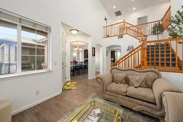 a view of a dining room with furniture wooden floor and chandelier
