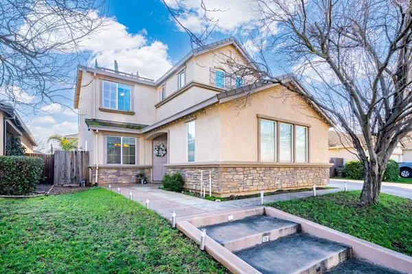 a view of an empty room with a fireplace and a window