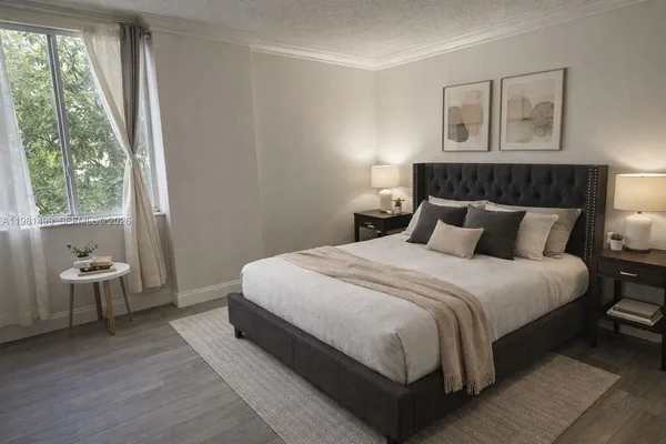 a bedroom with a large bed and two large window