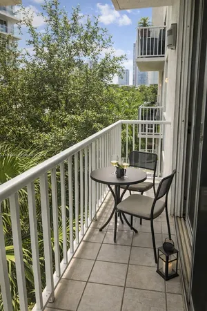 a view of a chairs and table in the balcony