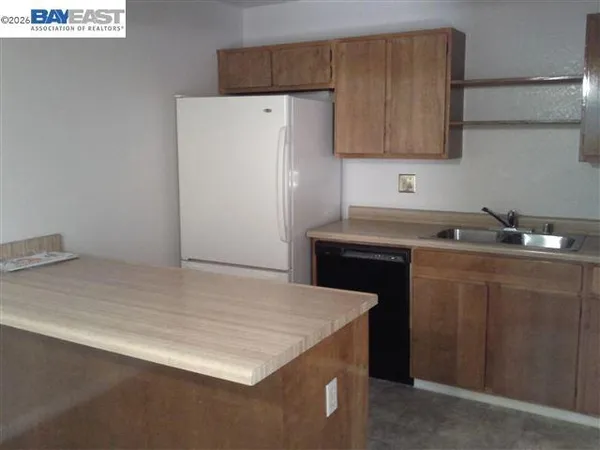 a kitchen with a sink and a refrigerator