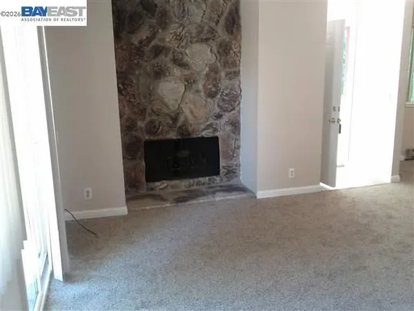 a view of empty room with a fireplace