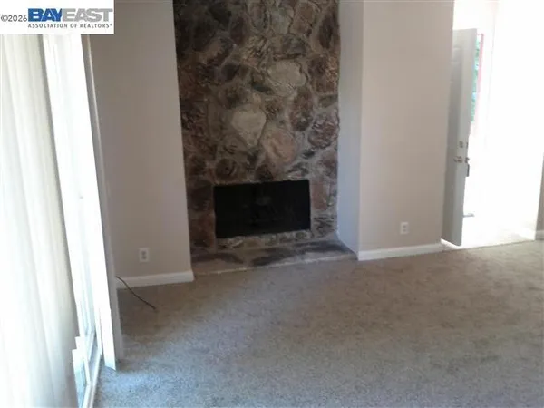 a view of empty room with a fireplace