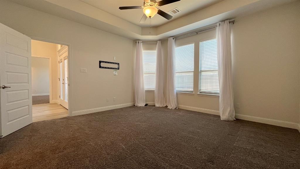 5304 Babcock Road McKinney, TX 75071 - Photo 12 of 27 an empty room with windows and ceiling fan