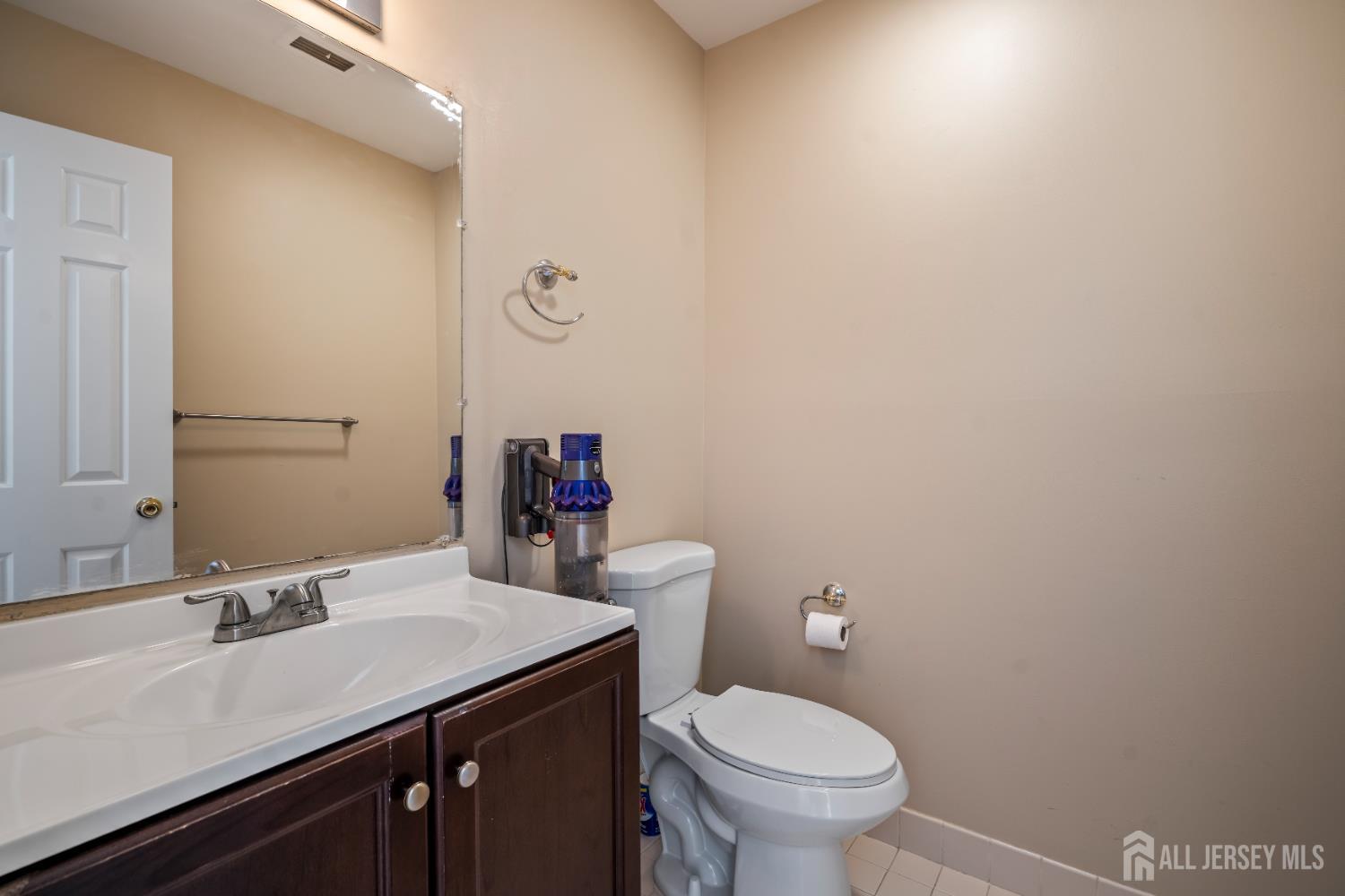 58 La Rue Lane East Brunswick, NJ 08816 - Photo 11 of 26 a bathroom with a sink a toilet and mirror