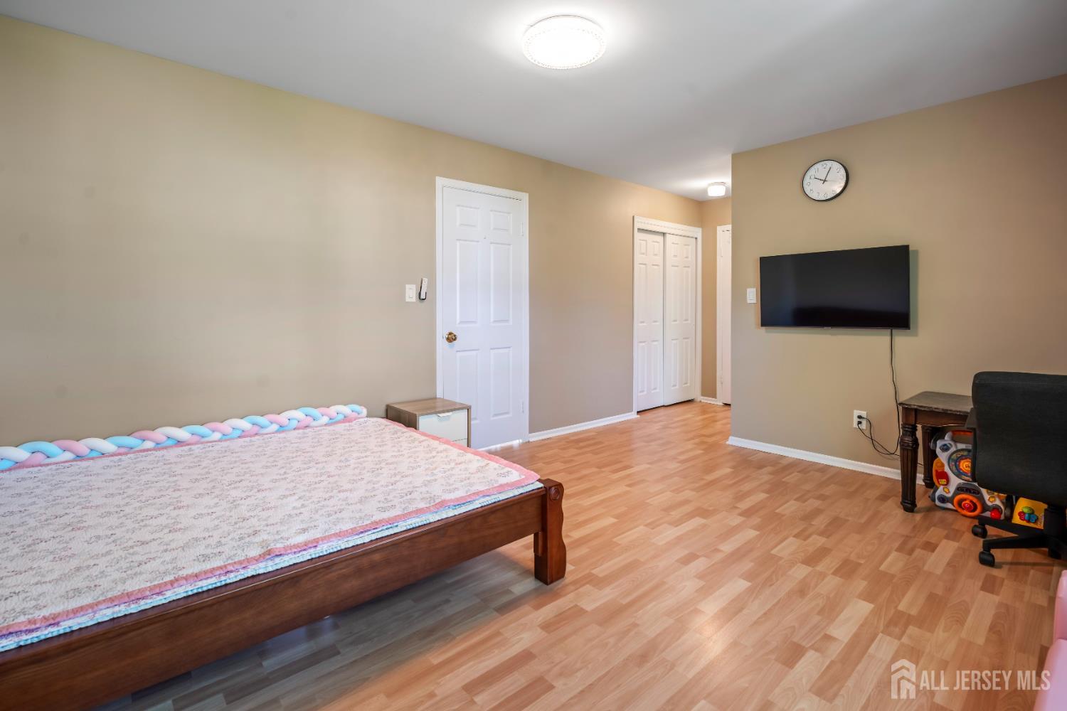 58 La Rue Lane East Brunswick, NJ 08816 - Photo 13 of 26 a bedroom with a bed and a flat screen tv