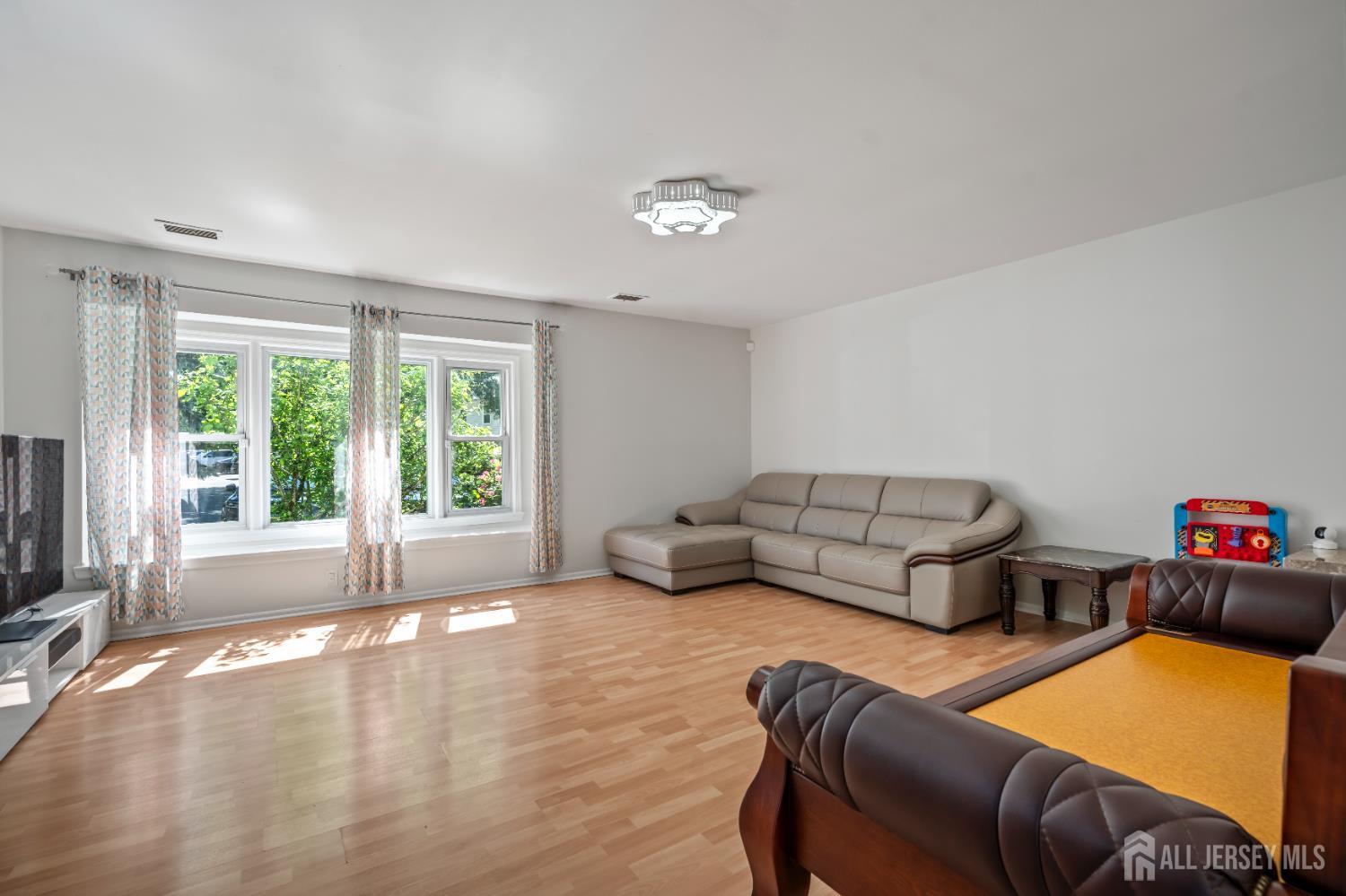 58 La Rue Lane East Brunswick, NJ 08816 - Photo 2 of 26 a living room with furniture ceiling fan and a window