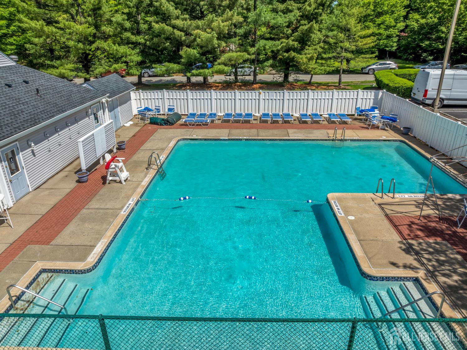 58 La Rue Lane East Brunswick, NJ 08816 - Photo 21 of 26 a view of a swimming pool with a lounge chairs
