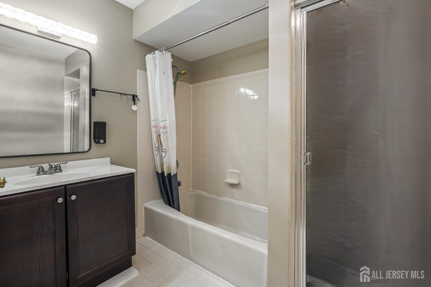 58 La Rue Lane East Brunswick, NJ 08816 - Photo 10 of 26 a bathroom with a tub sink and mirror