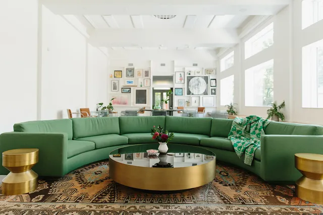 a living room with furniture and a potted plant