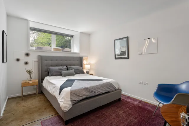 a view of a patio with a table and chairs and potted plants
