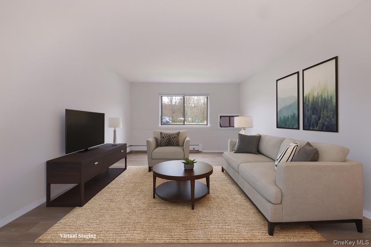 27 Tanager Road, Unit 2701 Monroe, NY 10950 - Photo 12 of 23 a living room with furniture and a flat screen tv