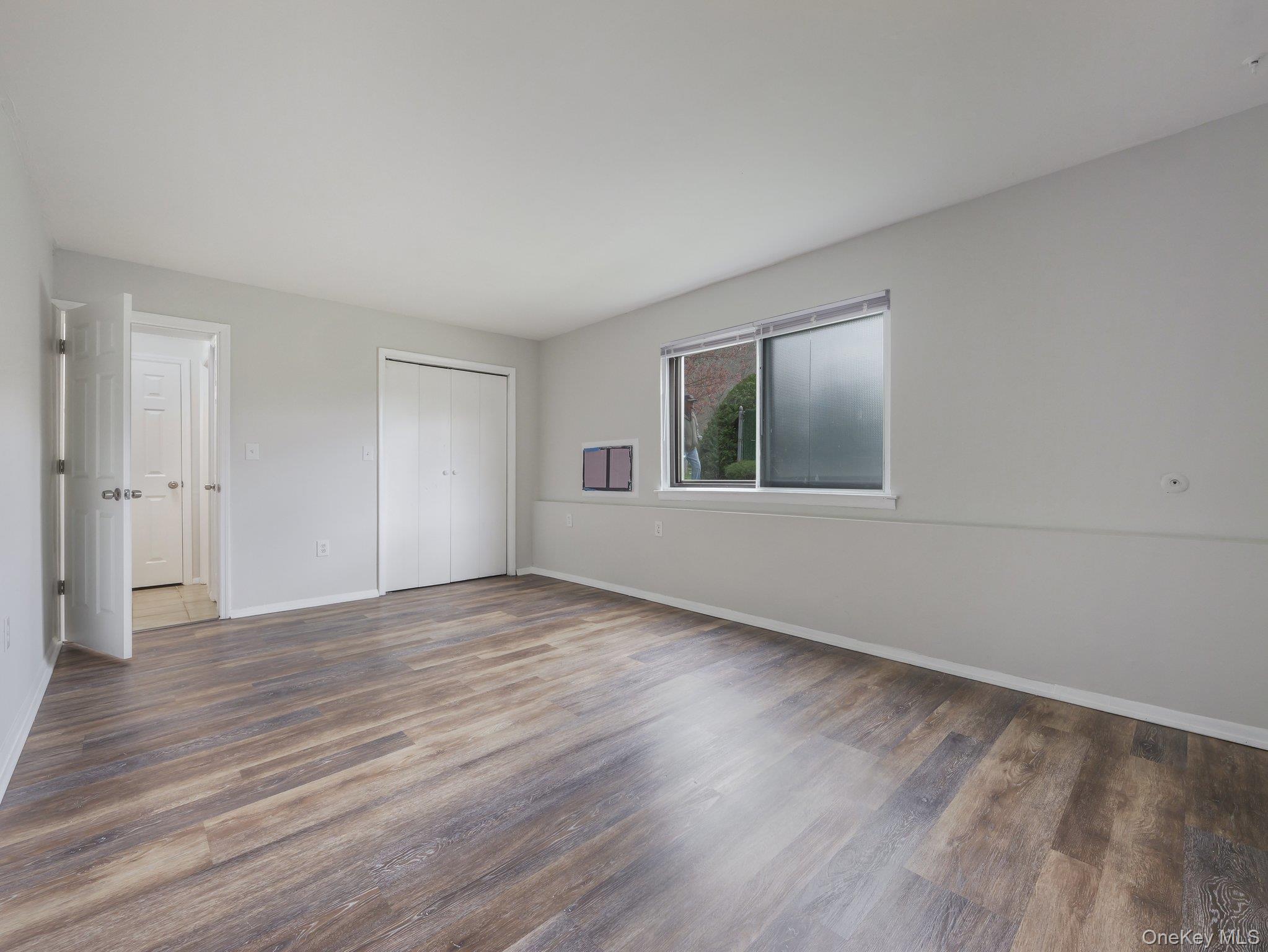 27 Tanager Road, Unit 2701 Monroe, NY 10950 - Photo 16 of 23 a view of an empty room with wooden floor and a window