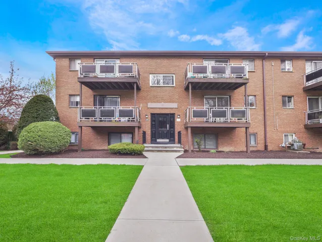 a front view of a house with a yard and table and chairs