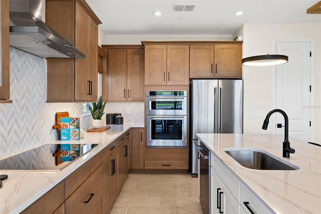 12829 Jade Empress Loop, Unit 201 Venice, FL 34293 - Photo 18 of 40 a kitchen with refrigerator and cabinets
