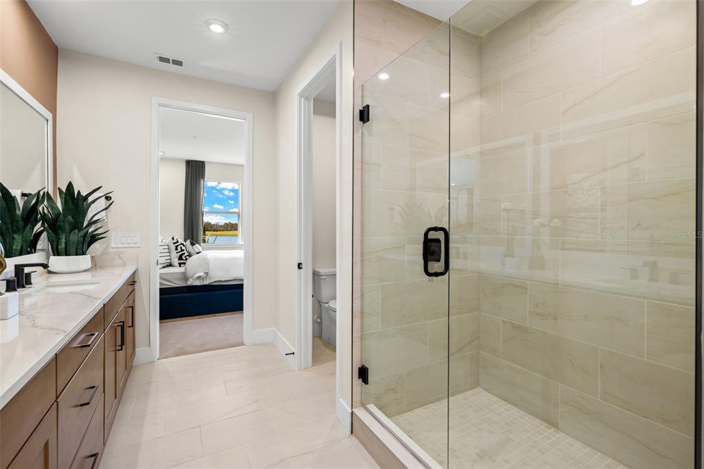 12829 Jade Empress Loop, Unit 201 Venice, FL 34293 - Photo 25 of 40 a bathroom with a shower and a sink