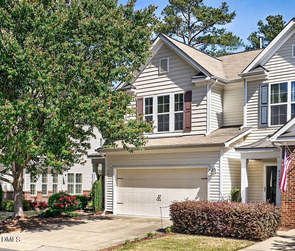 8215 Yaxley Hall Drive Raleigh, NC 27616 - Photo 1 of 42 a front view of a house with garden
