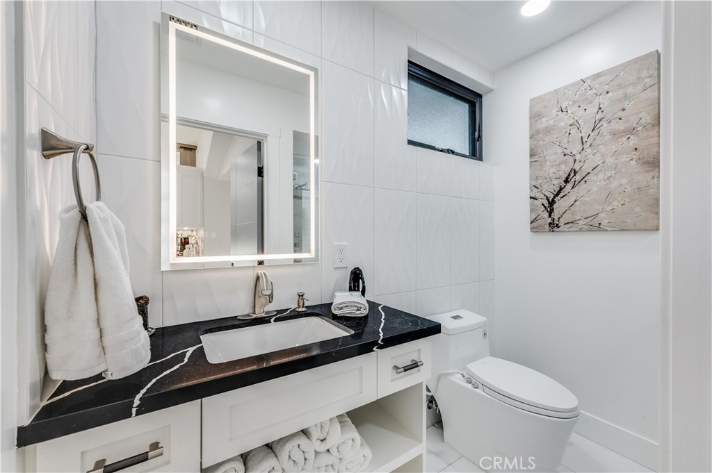 3890 Shadow Grove Road Pasadena, CA 91107 - Photo 21 of 63 a bathroom with a sink and a toilet