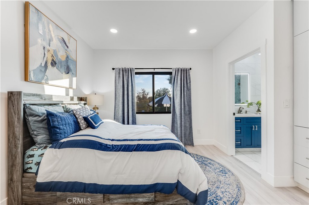 3890 Shadow Grove Road Pasadena, CA 91107 - Photo 30 of 63 a bedroom with a bed and dresser with mirror