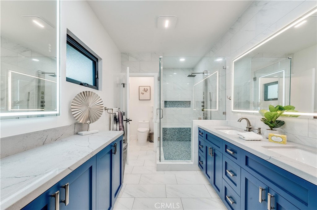 3890 Shadow Grove Road Pasadena, CA 91107 - Photo 40 of 63 a spacious bathroom with a granite countertop double sink and a mirror