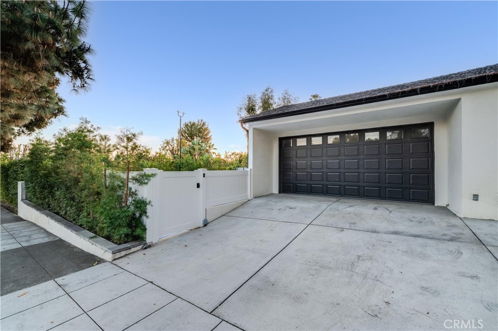 3890 Shadow Grove Road Pasadena, CA 91107 - Photo 48 of 63 a front view of a house with a garage and a fireplace