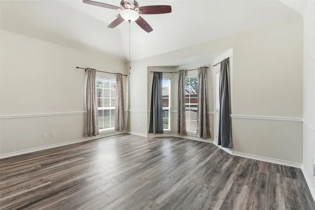 a view of a hallway with front door and wooden floor