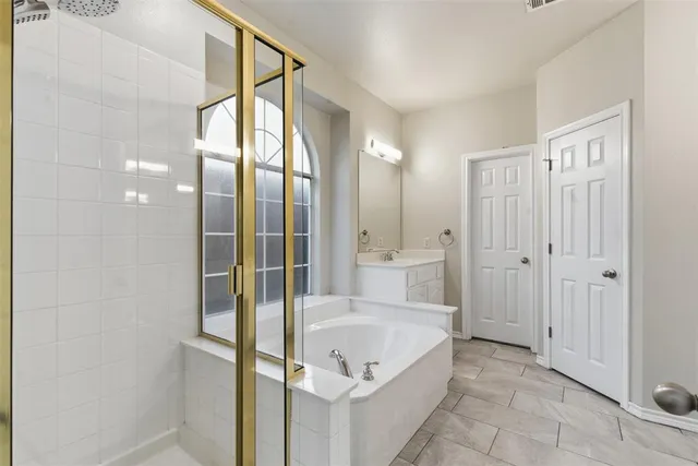 a spacious bathroom with a bathtub and a shower
