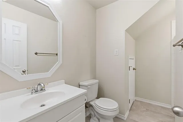 a view of an empty room with a window and a ceiling fan